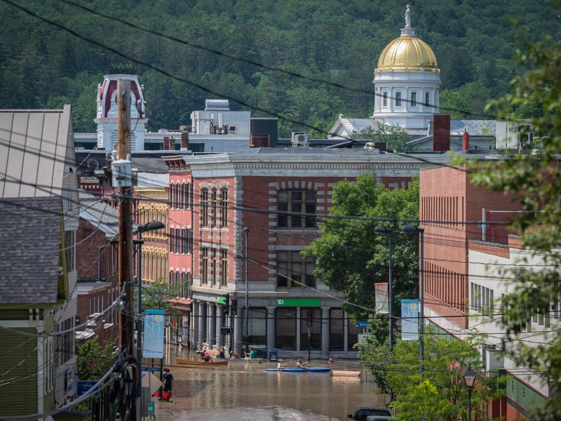 a view of a flooded street with a building in the background.